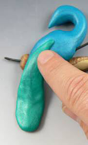 Blue clay being shaped